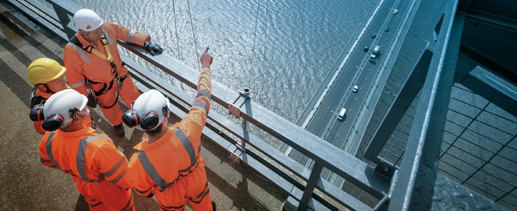 visual of four worker socotec on a bridge